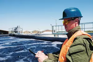An engineer controlling a quality of water ,aerated activated sludge tank at a waste water treatment plant
water, outdoors, people, man, male, waste, ecology, industry, microbiology, horizontal, working, factory, tank, engineer, helmet, quality, pipe, worker, storage tank, one man only, cleaning, caucasian man, water tanks, quality control, sewage treatment, protective clothing, working out, sewage, aeration, mid adult, hard hat, water treatment plant, serious man, wastewater treatment, drinking water, pollution